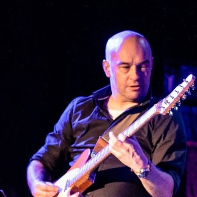 Tom Arham playing guitar